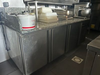 stainless steel counter top in a commercial kitchen with pots and pans on it