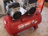 two air compressors sitting on top of a red cart