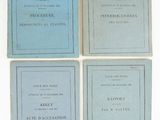 four books on a white surface with blue covers and black lettering