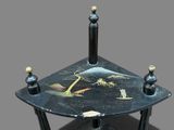 a black table with a painting on the top of it
