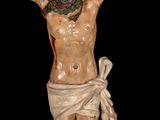 statue of jesus on the cross on a black background