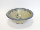 a blue and white bowl with a bird on it