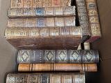 a box full of old books sitting on a table
