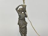 an image of a statue of a woman holding a lamp on top of a table
