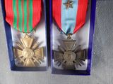 two medals that are in a blue box on a table