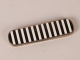 a black and white striped tie bar sitting on a table