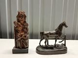 a statue of a woman and a horse on a table
