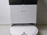 a robot that is sitting on the floor next to a cooler