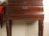 a small wooden desk with a bird on top of it