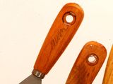 three wooden utensils that are next to each other
