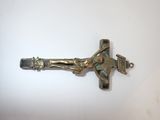 brass crucifix on a white surface with a cross on it
