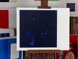 a picture of a painting on a easel in a room