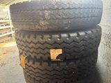 three tires stacked on top of each other in a garage