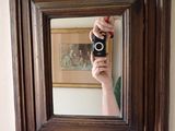 a person taking a picture of themselves in a mirror