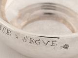 an image of a close up of a silver ring on a white surface