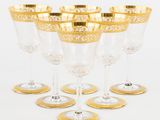six verres à vin à bord doré empilés les uns sur les autres