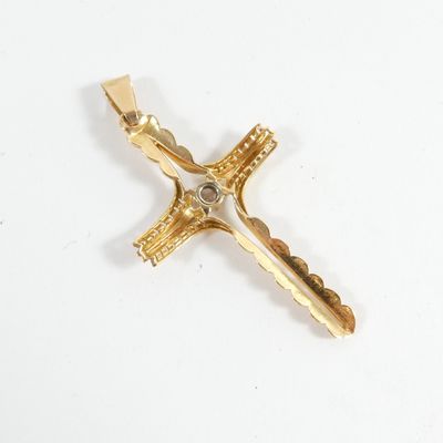 a close up of a cross on a white surface with a white background