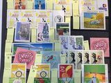 a lot of stamps on the table with post - it notes