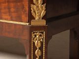 a wooden chest of drawers with gold decorations on it
