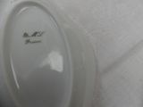a white plate with green writing on it sitting on a table