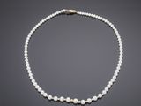 a cultured pearl necklace with a gold clasp