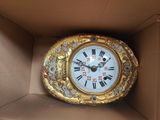 a clock that is in a box on the table