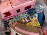 a pink toy truck and some other toys in a plastic bag