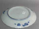 a white plate with blue flowers on it sitting on a table