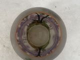 a white bowl with a purple and green design on it