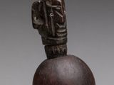 an image of a wooden sculpture of a person with a head on top of it