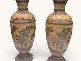 two vases sitting side by side on a white surface