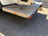a white truck with a flat bed on the back of it