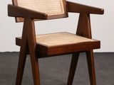 the chair is made of wood and has a woven seat