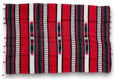 a red, black and white striped rug with fringes