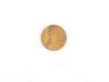 a close up of a gold coin on a white surface