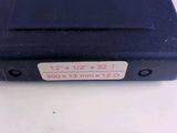 an image of a black plastic case with a red and white sticker on it