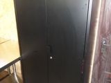 une armoire noire dans un coin de la pièce