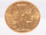 a close up of a gold coin on a white surface