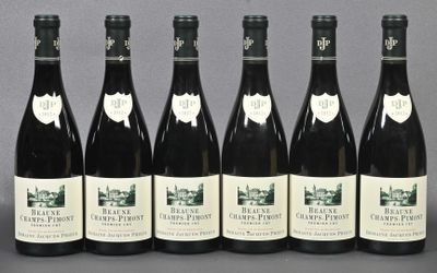 six bottles of wine are lined up in a row on a table
