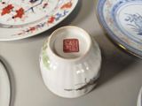 a white vase with a red and blue design on it