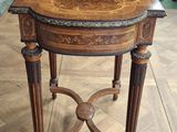 a small table with a wooden top on a wooden floor
