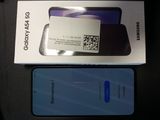 une boîte sur laquelle figure un code QR, à côté d'un téléphone Samsung
