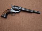 a gun that is sitting on top of a brown surface