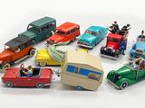 many toy cars that are sitting on a white surface
