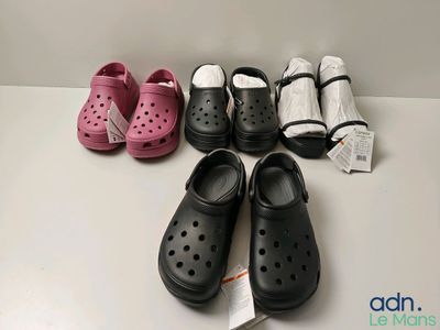 several pairs of crocs are lined up on a table