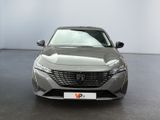 the front view of a grey car in a showroom