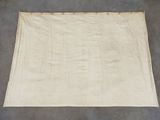 an old white cloth on a gray surface