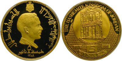a close up of a gold coin with a picture of a man