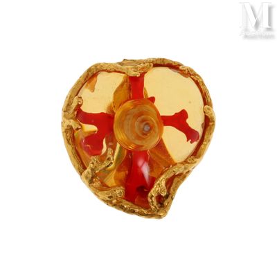 a gold ring with a red and yellow design on it
