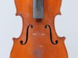 an old violin sitting on top of a white surface